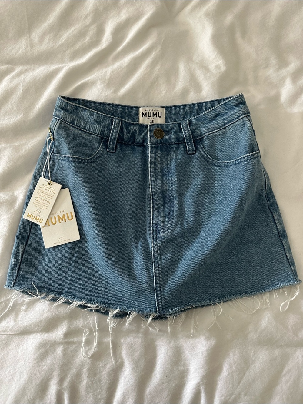 Show Me Your Mumu Skatesboro skort in a light denim wash with a raw hem size 25